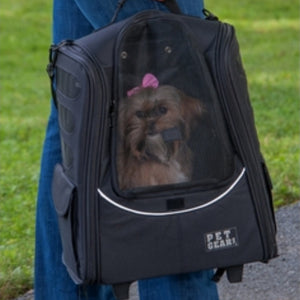 a close up image of a shih-tzu inside a 5-in-1 Pet Carrier [Backpack/Tote/Roller Bag/Carrier/Car Seat] being carried by a lady in blue jeans 