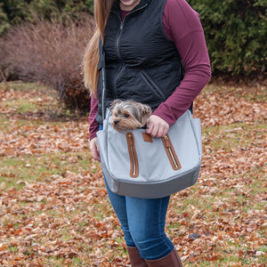 a lady in white carrying her dog outdoors on a Sling Pet Carrier Purse, Fog