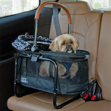 a fluffy dog sticking his head out of an animal printed dog carrier that is tucked at the backseat of the car