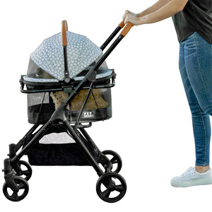 a woman pushing a silver pearl design dog stroller in white background