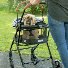 a woman walking her dog inside a silver pearl designed dog stroller