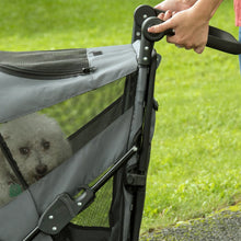 a close up image of a handle bar of a grey dog jogger with the dog inside