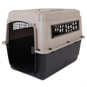 A close up image of a black and grey dog steel crate in white background