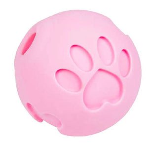 a close up image of a pink dog ball treat dispenser with paw engraved to it 
