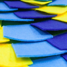 close up image of a multi colored puzzle pad for dog