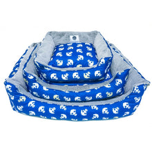 three blue dog bed with anchor prints  on different sizes stacked together