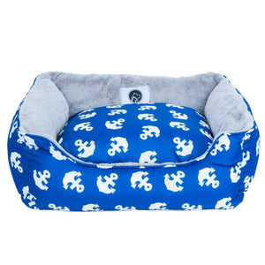 full view image of a small blue dog bed with anchor prints 