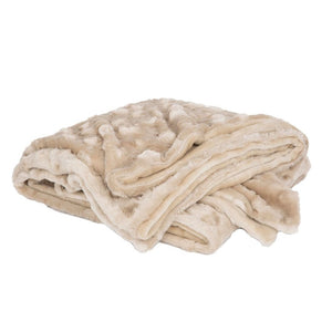 a folded cream colored velvet blanket