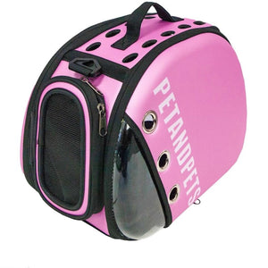 a close up image of a pink dog sling carrier with breathing holes on top next to strap handle and side pockets facing front 