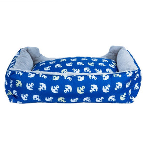 back view image of a blue dog bed with anchor prints 
