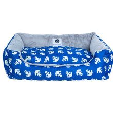 a front view image of a blue dog bed with anchor prints 