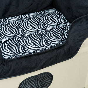 a close up image of a cream bedside dog lounge with zebra prints  base