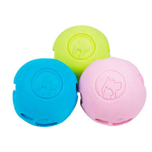 a set of multi colored dog ball treat dispenser in green, blue and pink
