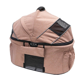 a close up image of a champagne colored dog carrier with side pockets