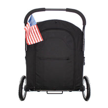 back view image of a black dog stroller withs its back closed and a USA Flaget attached on the side handle bars 