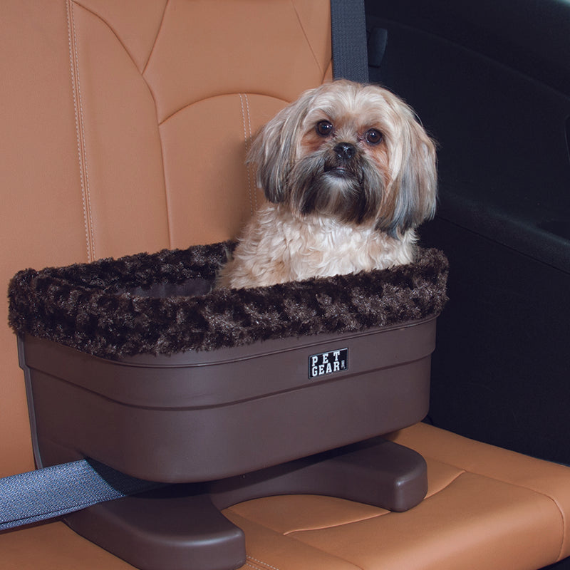 A close up image of a shih-tzu sitting on a brown leather car seat in a Bucket Seat Dog Booster with Chocolate Insert, 17