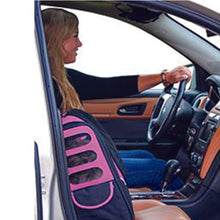 a close up image of a driving lady next to her dog in her passenger seat inside a pink -in-1 Pet Carrier [Backpack/Tote/Roller Bag/Carrier/Car Seat